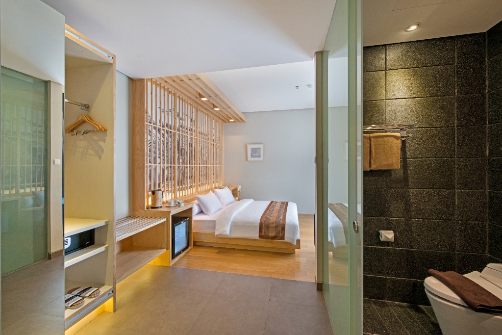 Deluxe room interior with king bed and balcony light